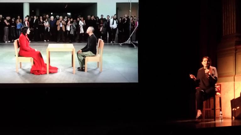 Lecture di Marina Abramović con la proiezione di alcune fotografie scattate nel corso della performance The Artist is Present eseguita al MoMa di New York nel 2010.