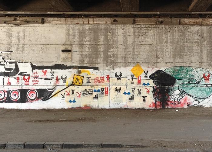 Stencilling on the Tank Wall. Photograph: Bahia Shehab, 2012.