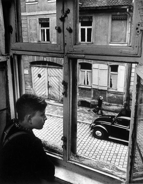 Boy looking out of window. Ansbach, Germany, 1954. Ph. Carl Mydans
